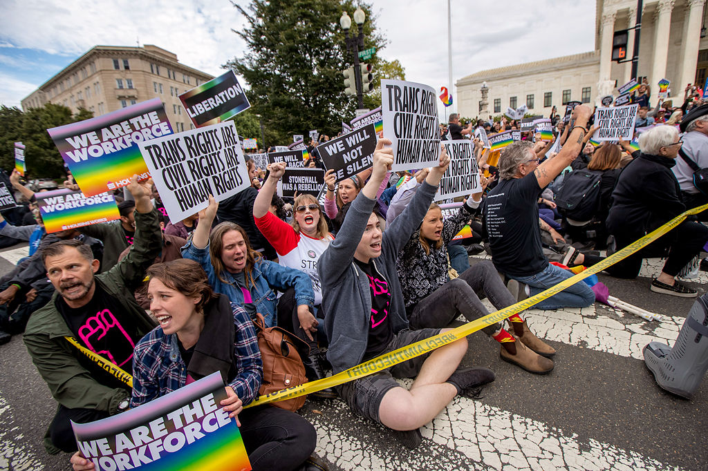 Supporters of LGBT rights sit in the street in front of the U.S. Supreme Court